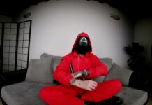 Tattooed Vixen in Red Jumpsuit Flaunts Her Bare Feet for Attention